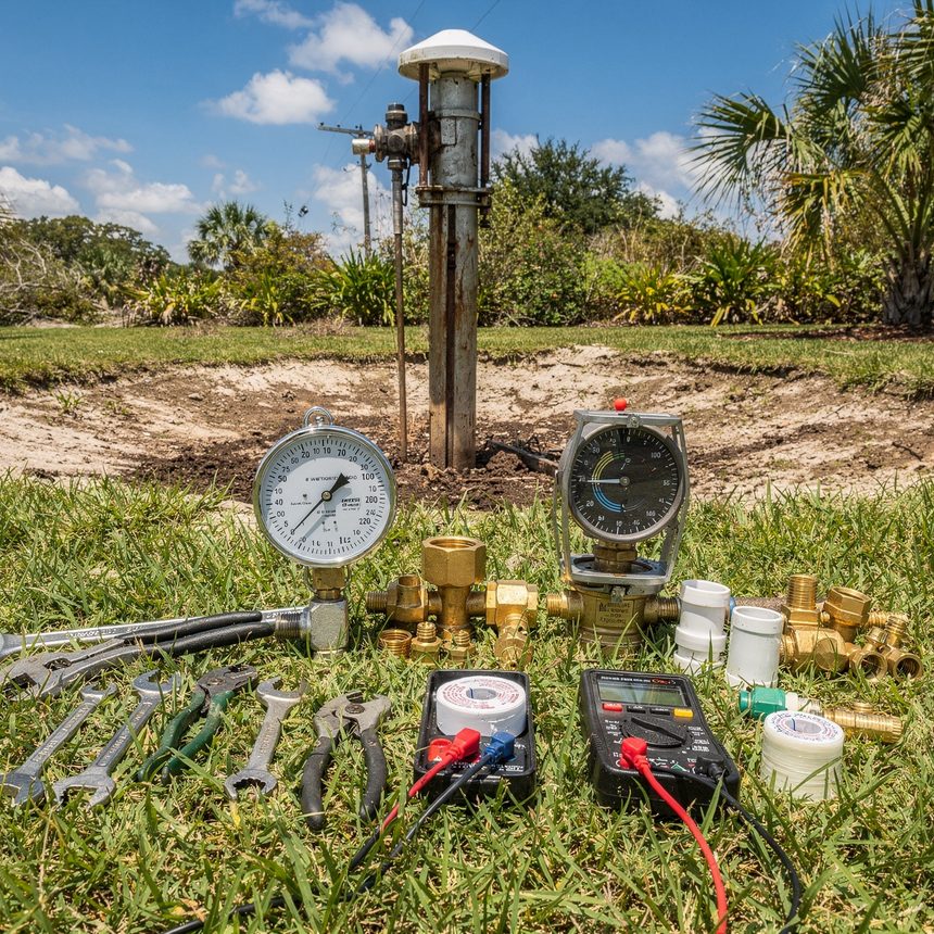Well pump technician servicing a pressure tank in Sarasota, FL